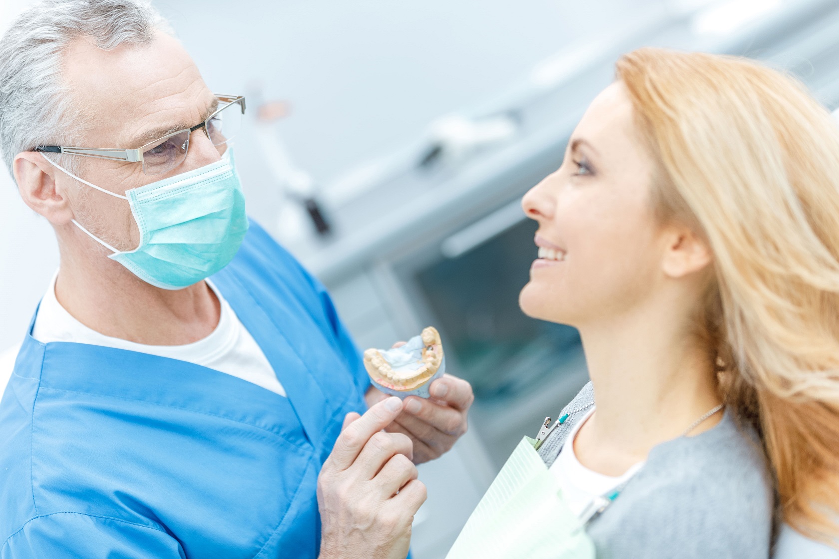 Doctor consulting with patient in dental chair